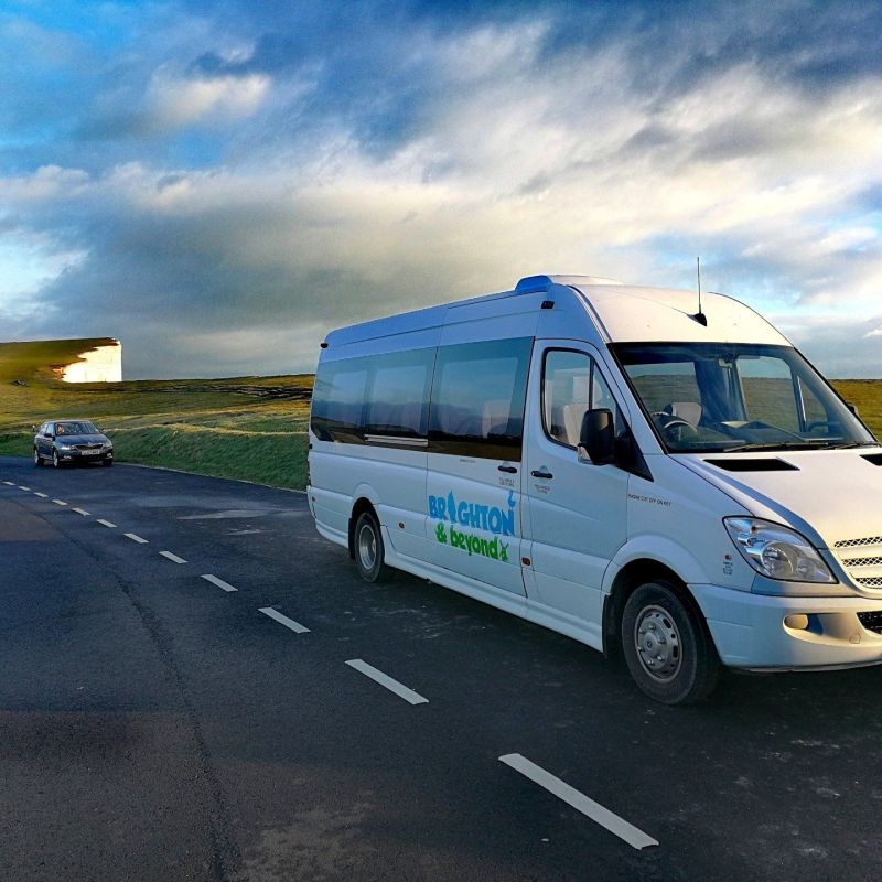 a blue truck parked on the side of a road