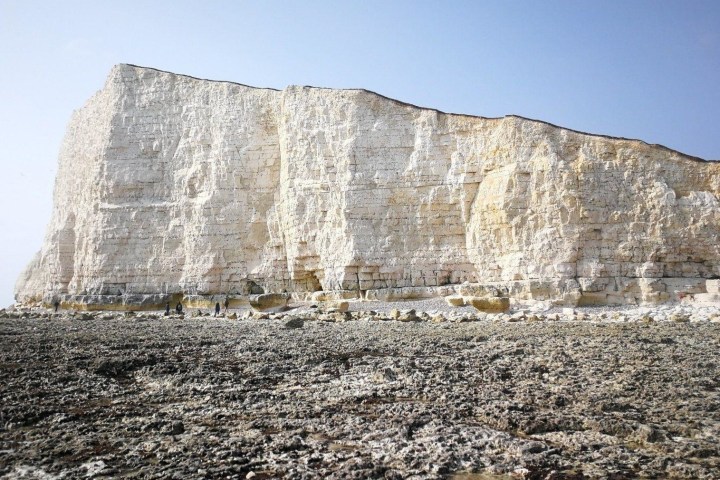 a stone building with a mountain in the background