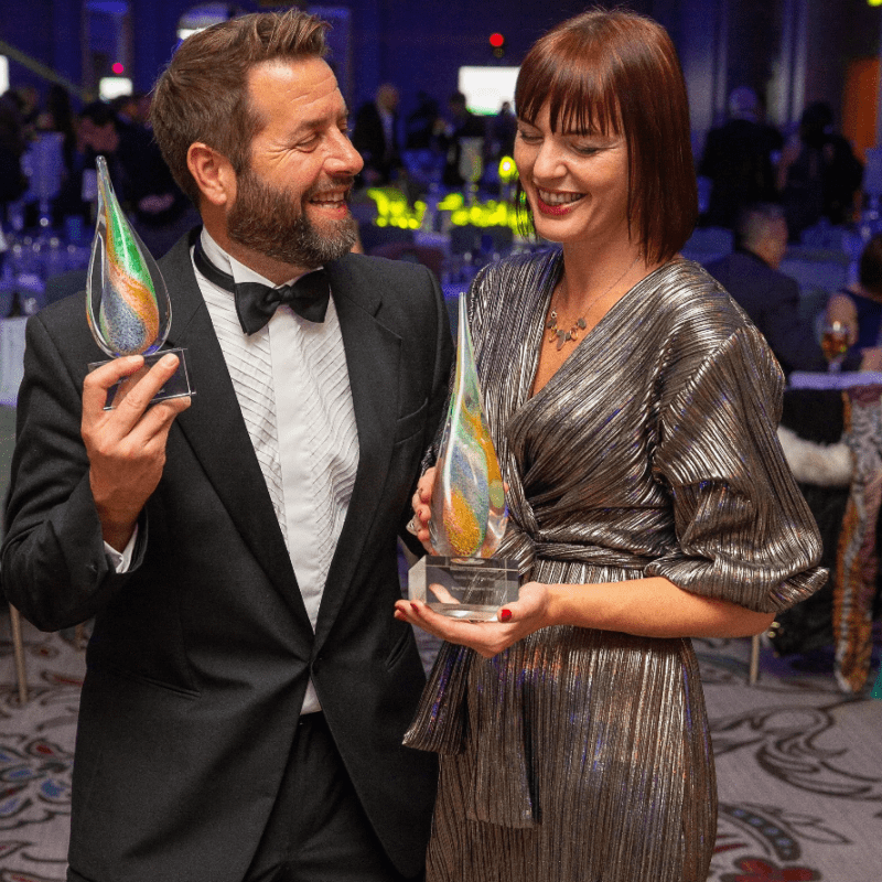 a person wearing a suit and tie talking on a cell phone