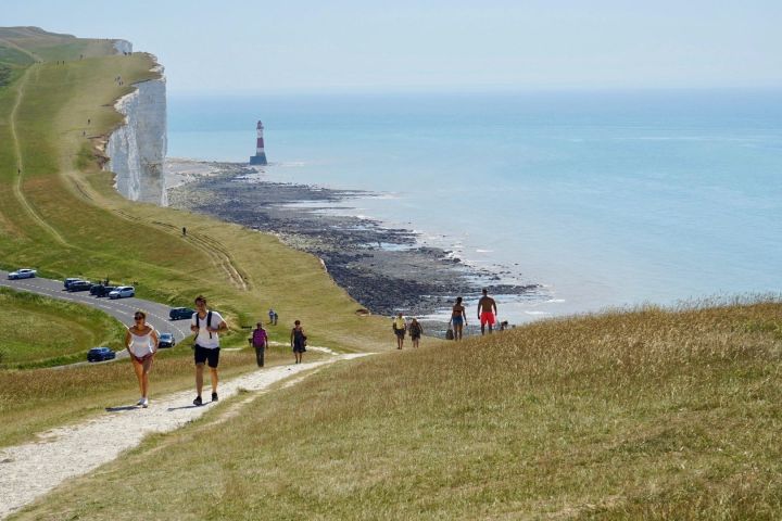 a group of people on a beach near a body of water