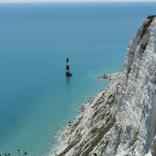 a body of water with a mountain in the ocean