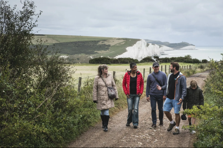 a group of people standing in front of a tree