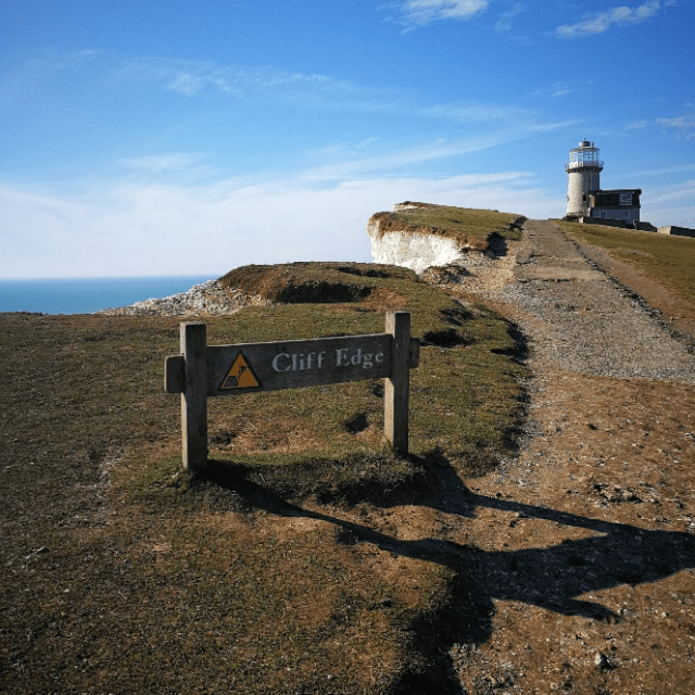 a bench on the side of a dirt field
