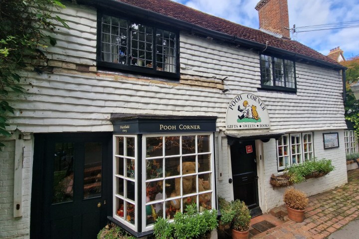 a house with bushes in front of a brick building