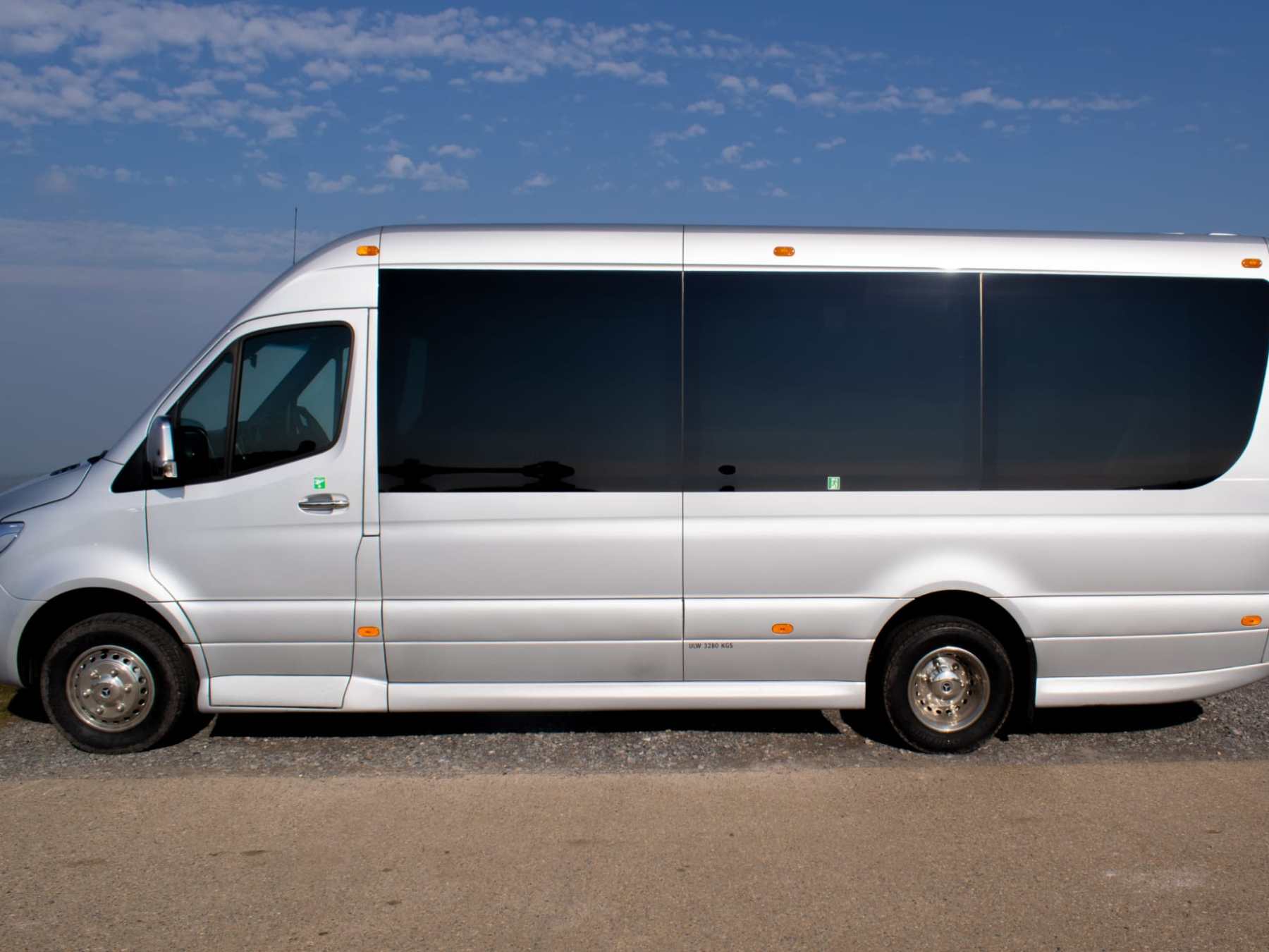 White van parked on gravel with a clear blue sky in the background.